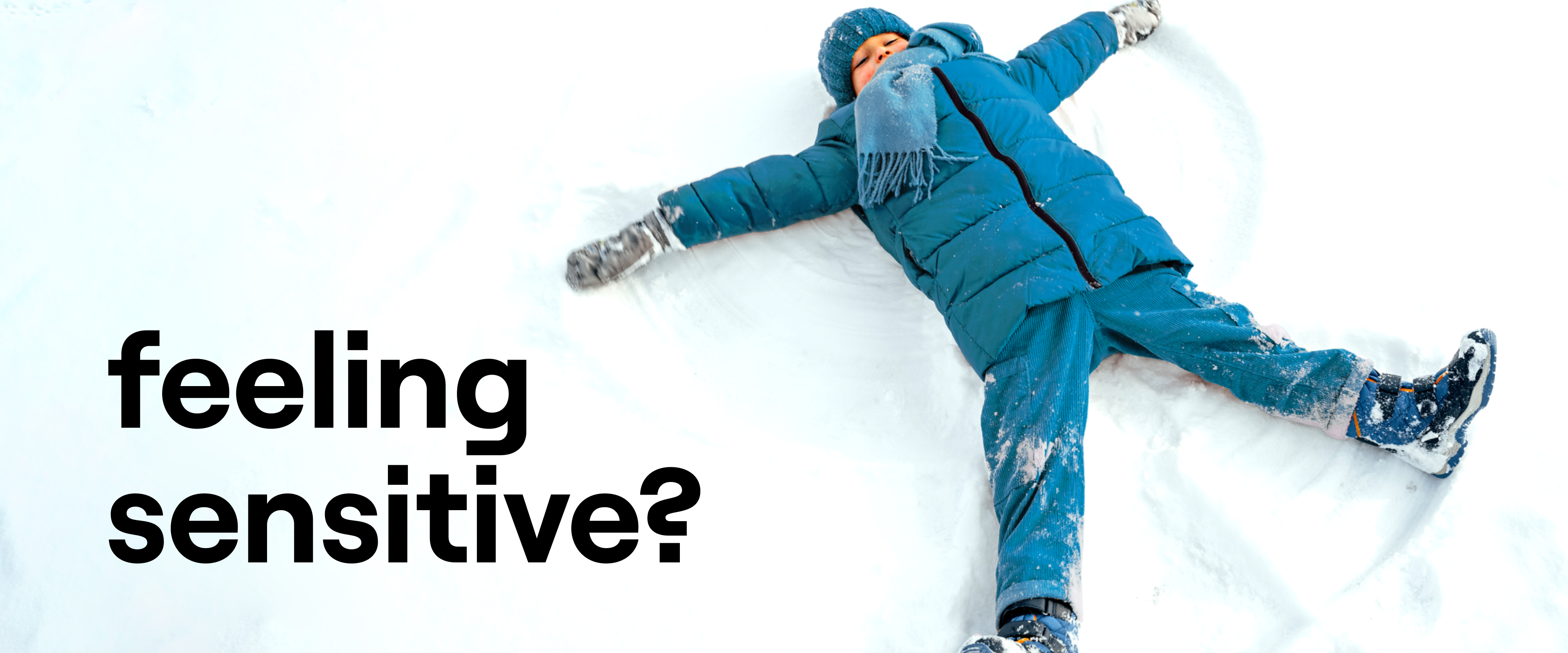 Child in snow making a snow angel.