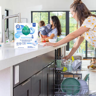 Family cleaning kitchen, person adding Auto Dish Pack to dishwasher