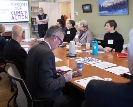 various business representatives at table discussing Climate Action 