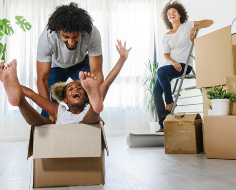 Family having fun with moving boxes.