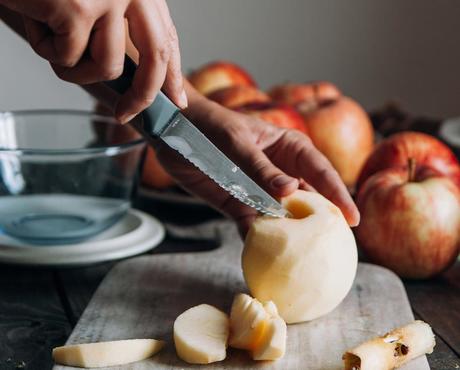 Hands Cutting Skinned Apple