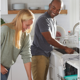 Man and woman loading a dishwasher