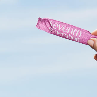 Person holding tampon against blue background