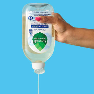 Easy Dose bottle, upside down, being squeezed. Blue background.